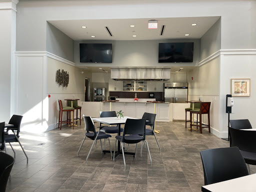 A modern dining area featuring sleek furniture and an open kitchen design.