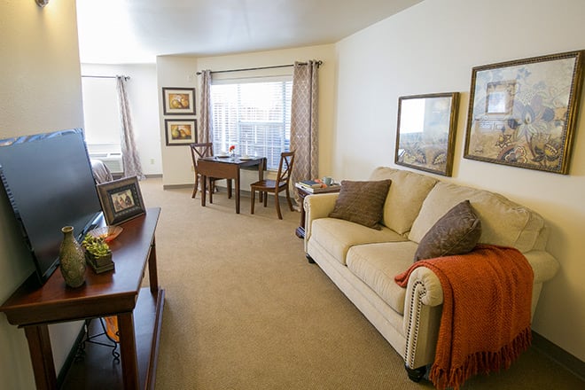 A cozy living room with a sofa, table, and decorative elements.