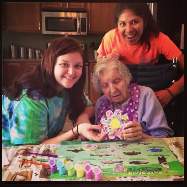Three people enjoying a crafting activity together at home.