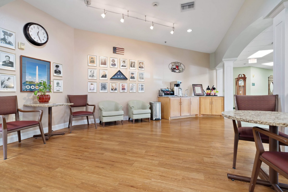 A modern waiting room with wooden floors and artwork on the walls.