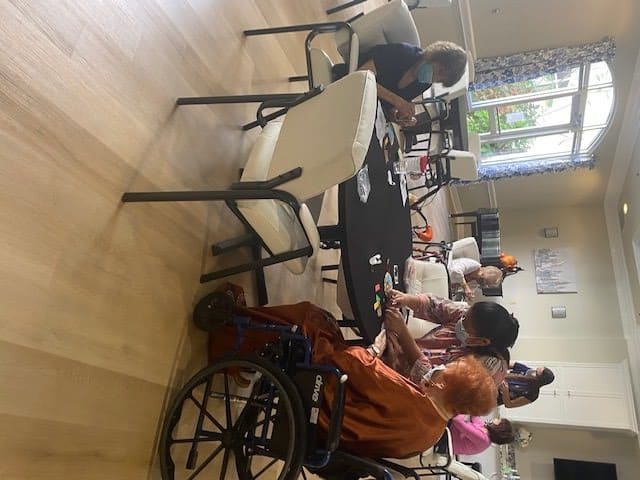 Elderly individuals participating in a group activity in a nursing home.