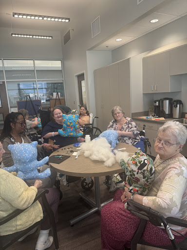 A group of elderly individuals engaging in a crafting session, fostering community and creativity.