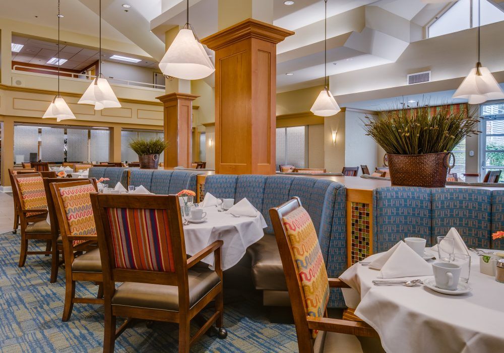A cozy restaurant interior with neatly arranged tables and warm lighting.