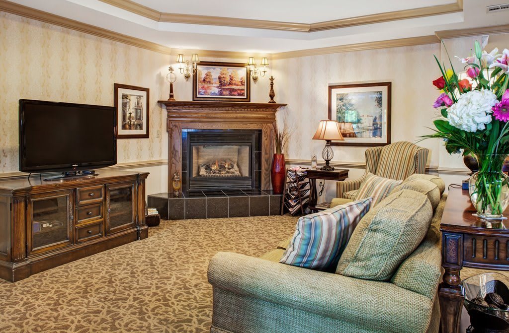 A cozy living room with a warm fireplace and comfortable seating.