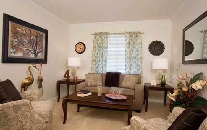 A cozy living room with a sofa, coffee table, and decorative elements.