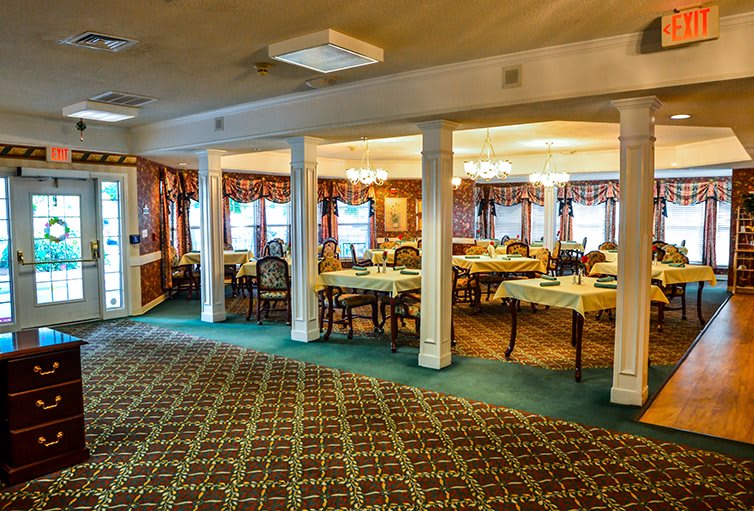 A cozy dining room with elegantly set tables and classic decor.