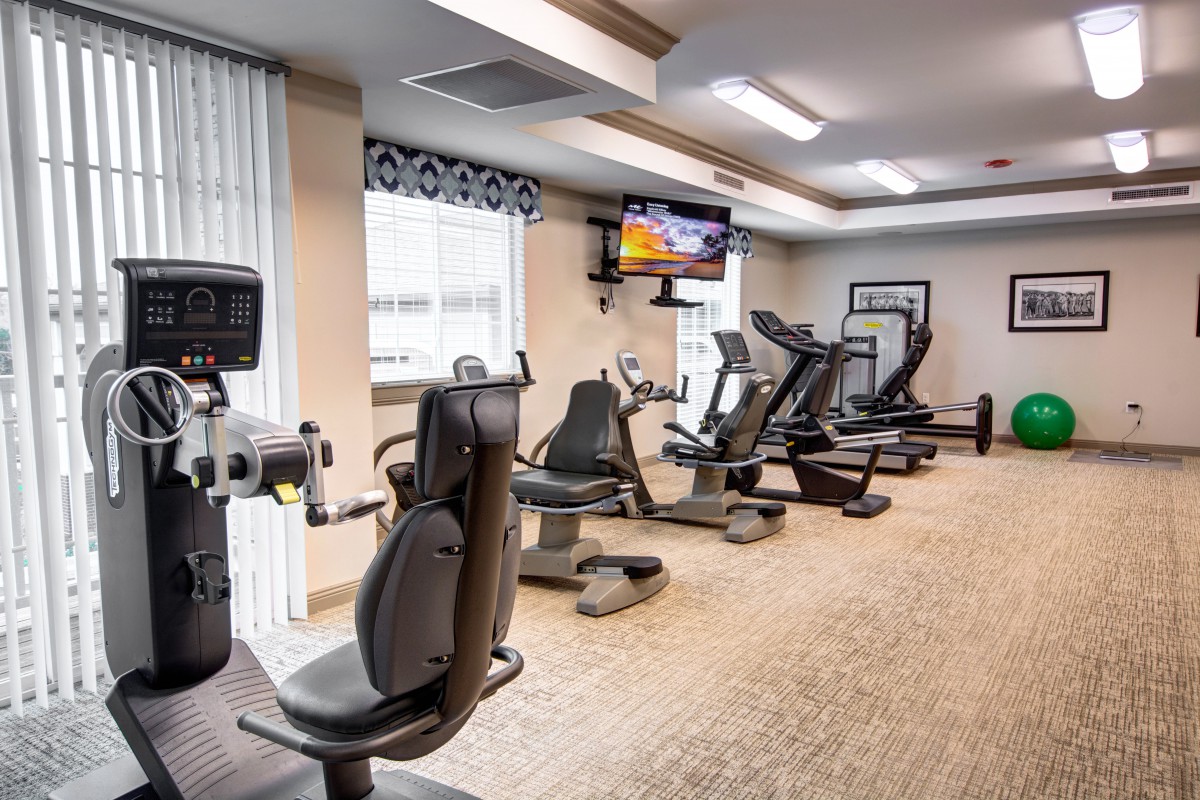 A modern gym equipped with treadmills and stationary bikes.