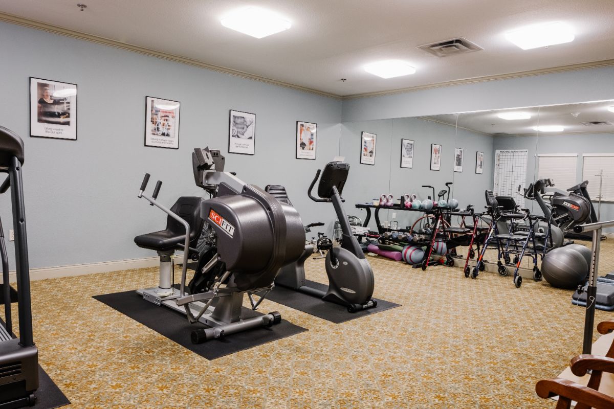 A small gym with various exercise equipment, including a stationary bike.