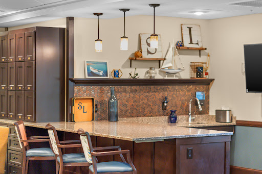 A stylish modern kitchen featuring a bar area with unique lighting and decorative elements.