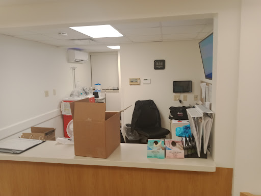 A view of a medical office reception area with equipment and a box.