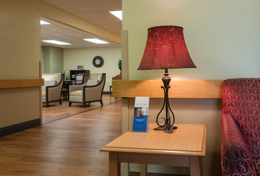 A cozy reception area featuring a stylish lamp and comfortable seating.