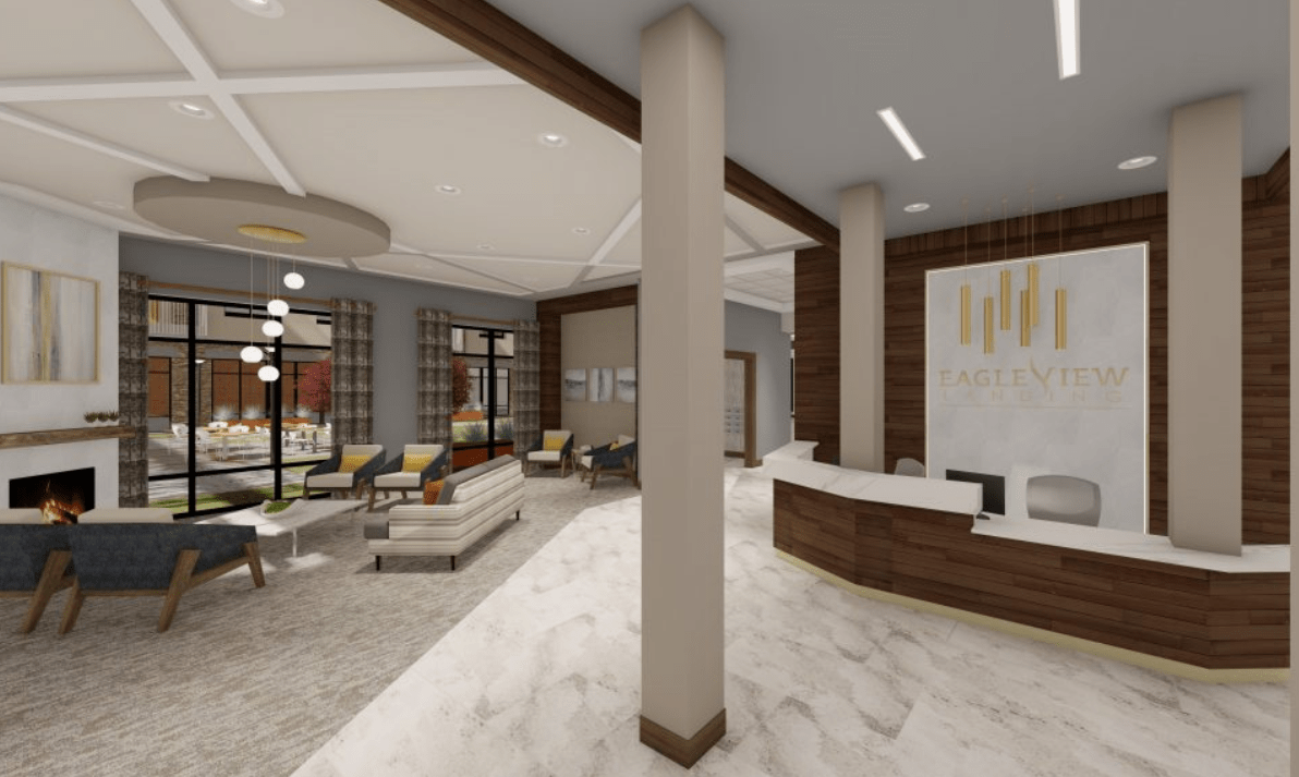 A modern and spacious lobby with seating and a reception area.
