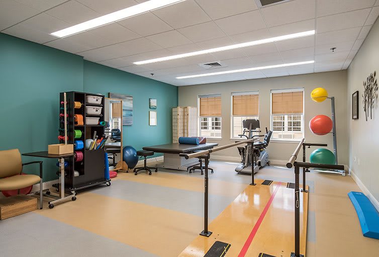 A well-equipped physical therapy room with various exercise tools and equipment.