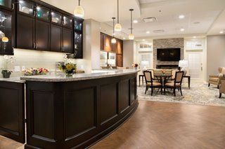 A modern kitchen with an island and adjacent dining area.