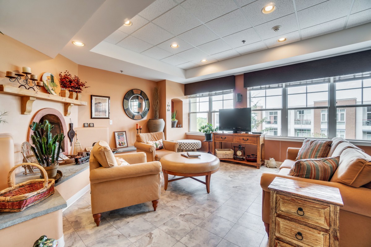 A cozy living room with comfortable seating and a large window providing ample natural light.