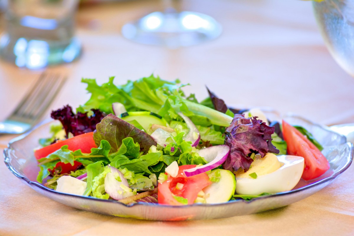 A fresh and colorful salad with mixed greens and tomatoes.