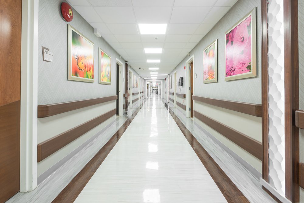 A clean and bright hospital hallway adorned with colorful artwork.