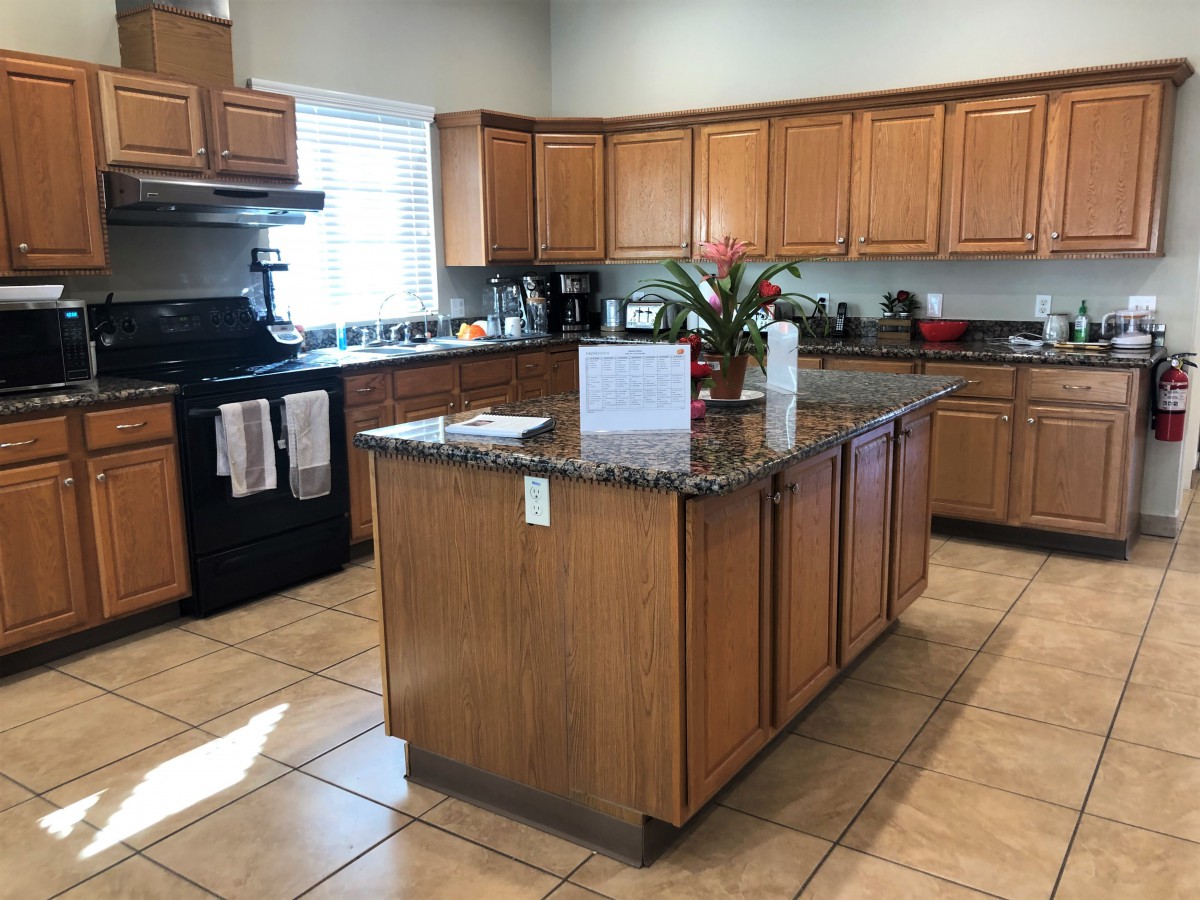 A modern kitchen with wooden cabinets and a central island.