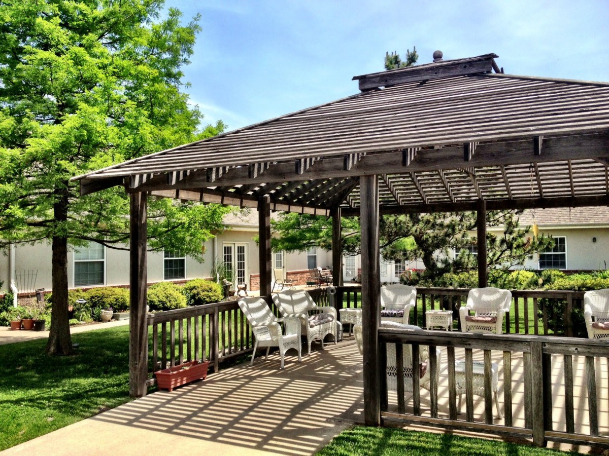 A charming gazebo with outdoor seating on a sunny day.