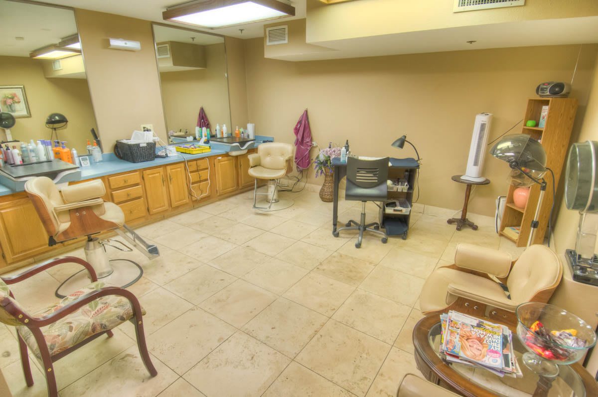 A spacious hair salon with styling chairs and mirrors.