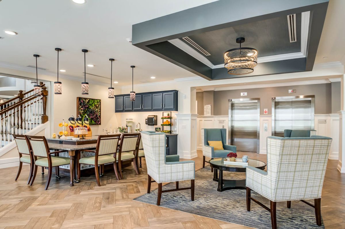 A modern open-concept kitchen and dining area featuring stylish lighting and contemporary furniture.