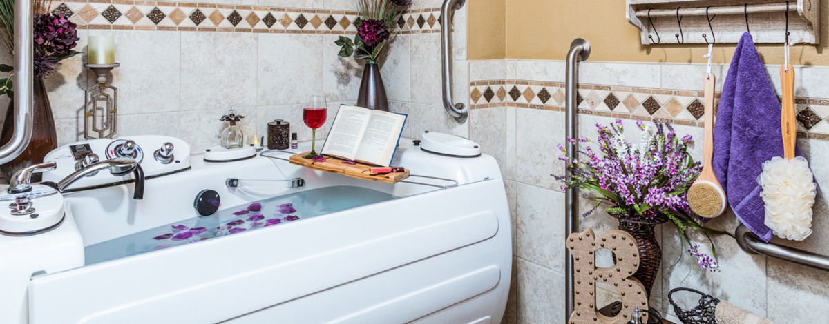 A luxurious bathtub setup with a book and wine, perfect for relaxation.