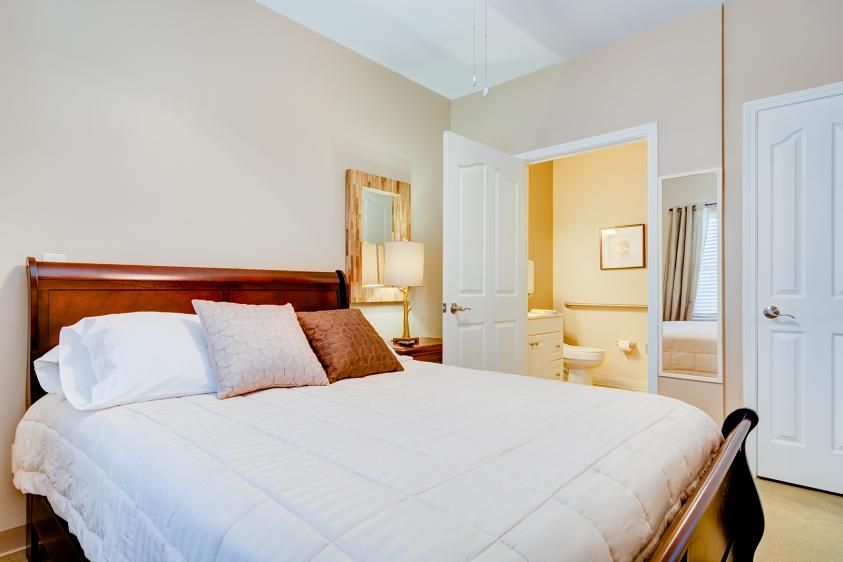 A cozy bedroom featuring a comfortable bed and warm lighting.