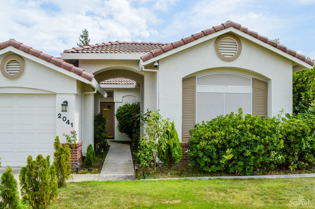 A suburban house with a landscaped front yard and pathway.