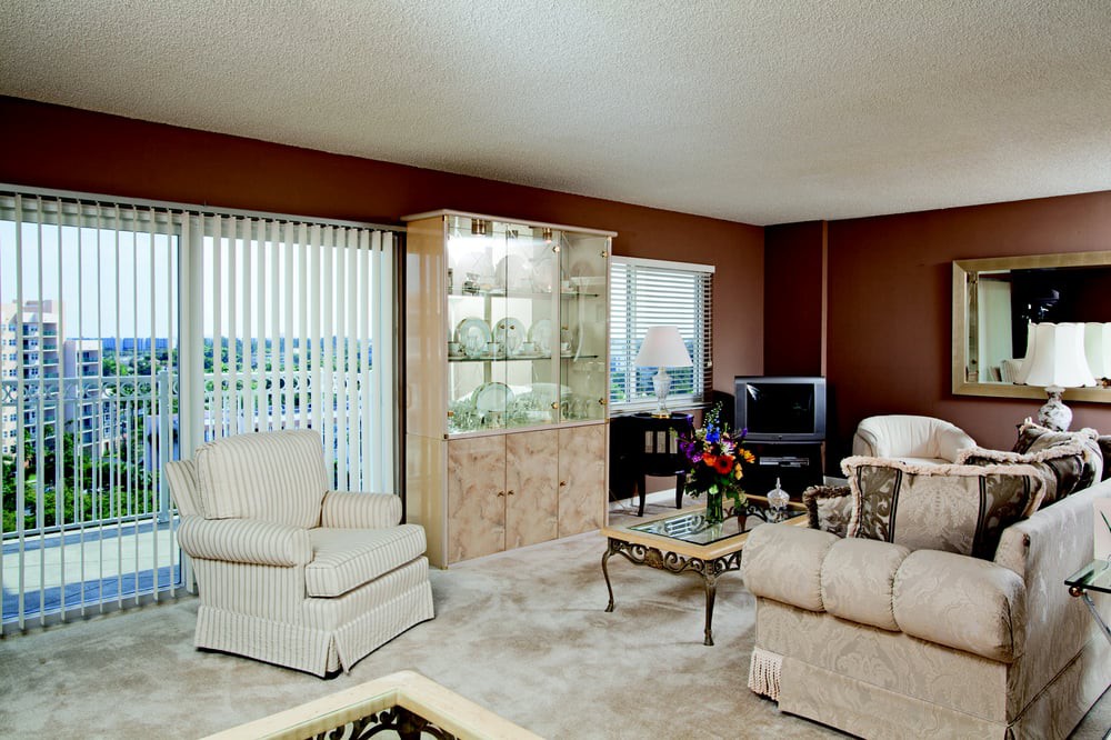 A cozy living room featuring comfortable seating, a cabinet display, and a television.
