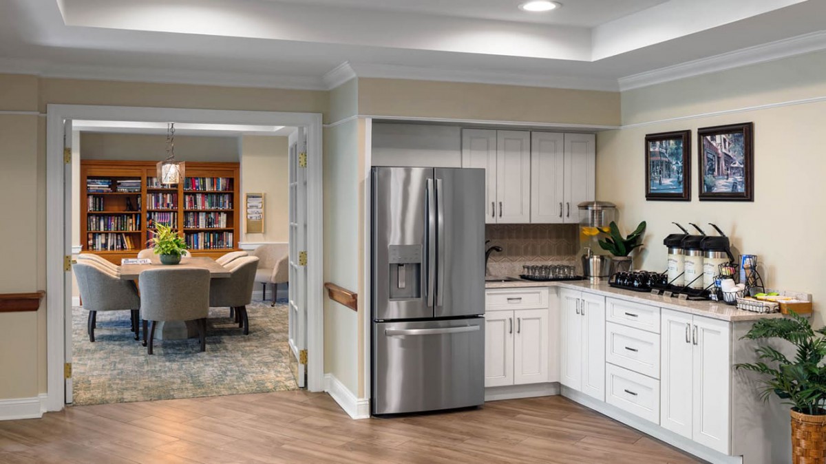 A modern kitchen featuring stainless steel appliances and open space.