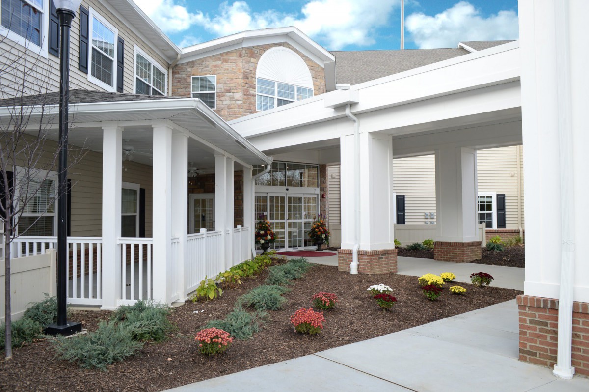 A welcoming building entrance with landscaped surroundings.
