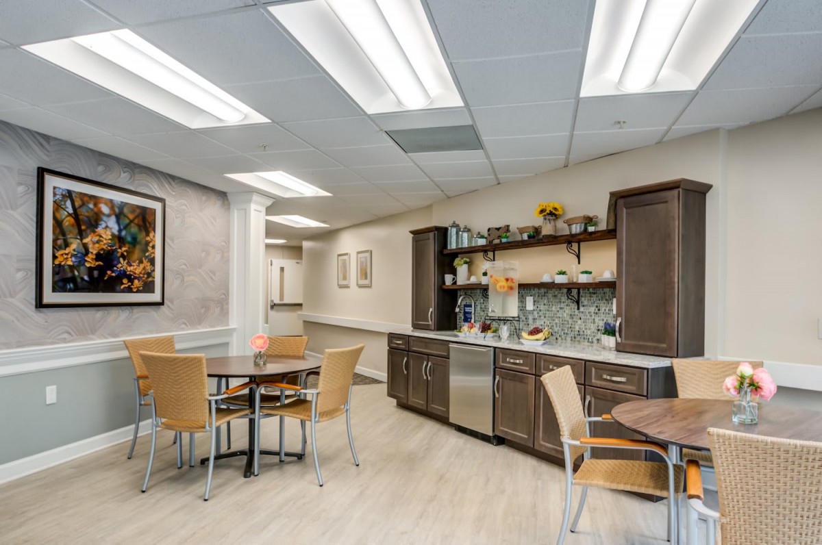 A modern break room with wooden furniture and contemporary lighting.