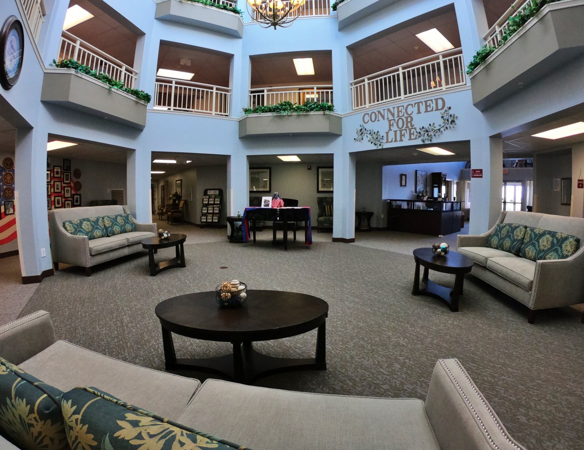 A spacious and well-lit lobby area with comfortable seating arrangements and decorative plants.