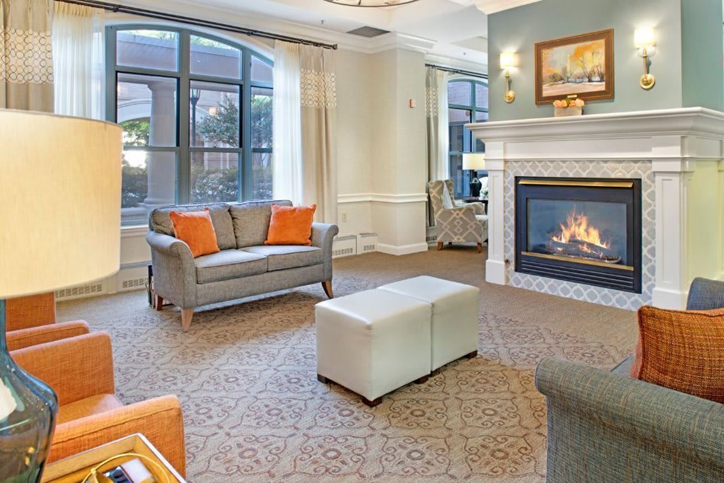 A modern living room with a fireplace and comfortable seating.