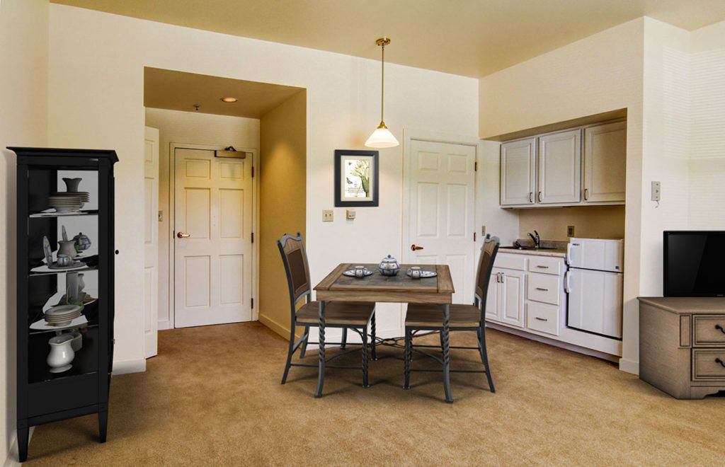A cozy kitchen and dining area with a wooden table, chairs, and modern appliances.