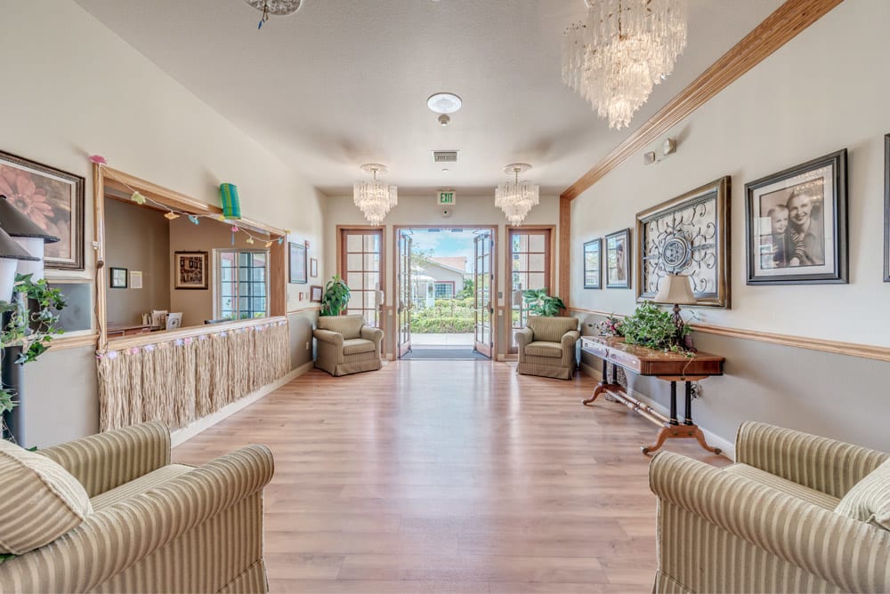 A spacious and elegantly designed lobby with comfortable seating and large chandeliers.