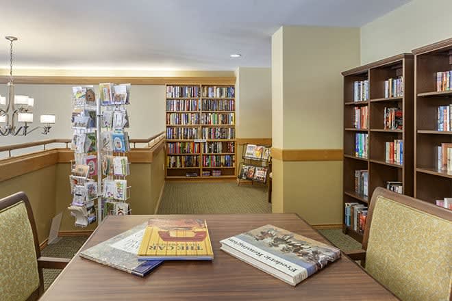 An inviting library space with bookshelves and a reading table.