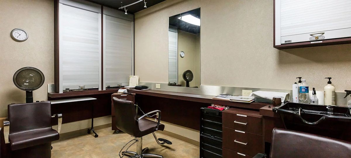 An empty professional office space with desks and chairs.