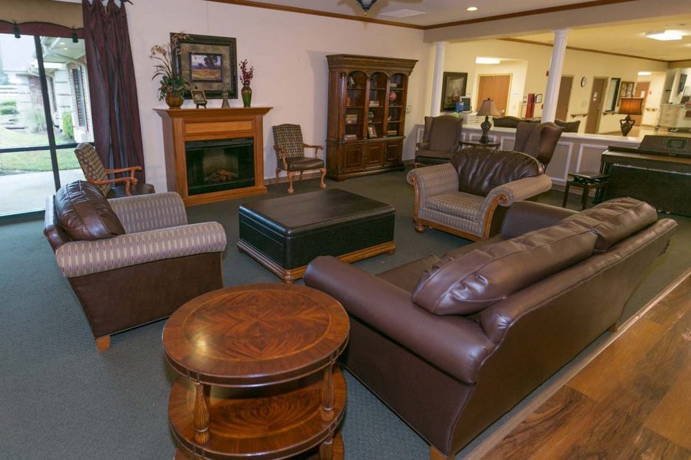 A cozy living room with leather sofas and a fireplace.