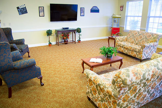 A cozy living room with comfortable seating and a large television.