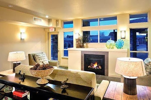A cozy and modern living room featuring a fireplace and stylish decor, perfect for relaxation.