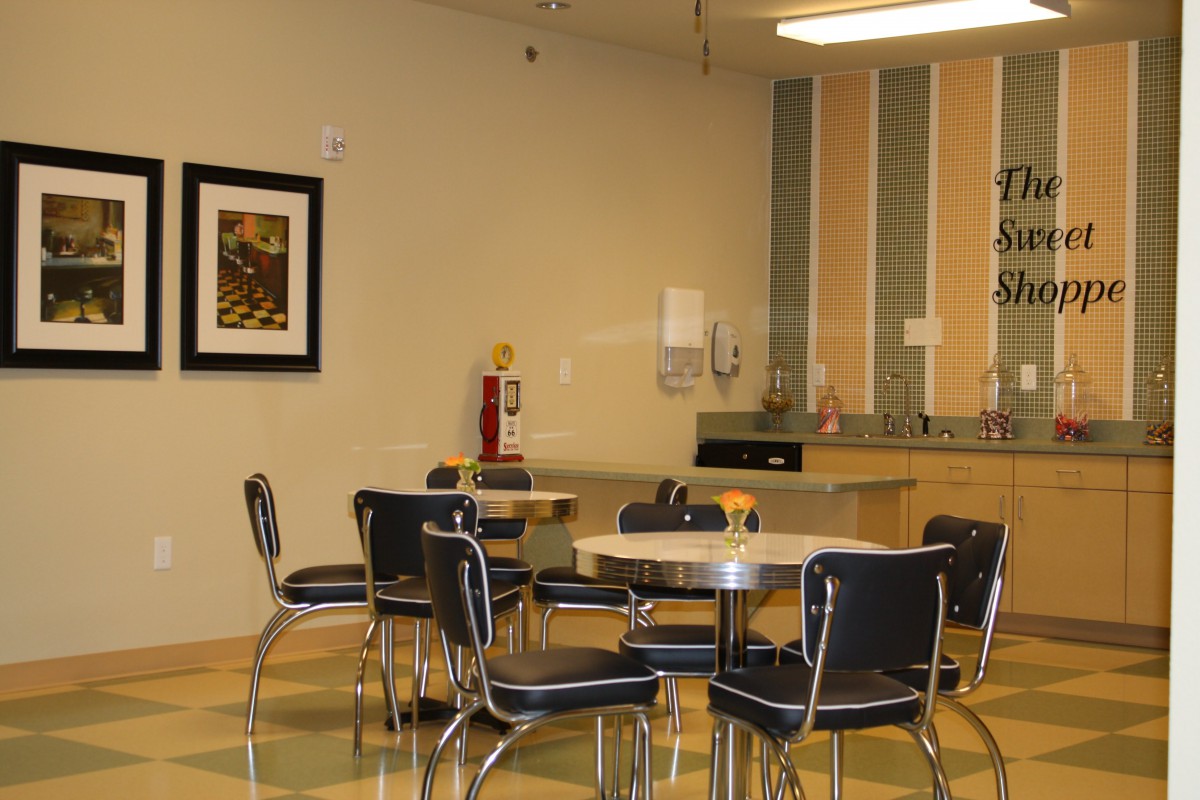A modern dining area with tables and chairs in a cafe setting.
