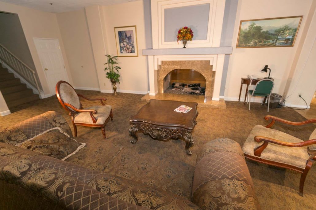 A traditionally decorated living room featuring cozy furniture and a fireplace.