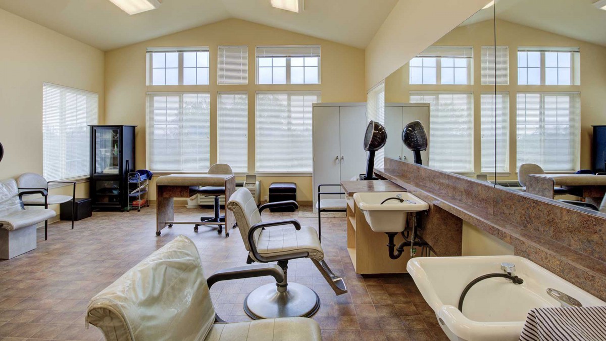 Interior view of a hair salon with styling chairs and equipment.