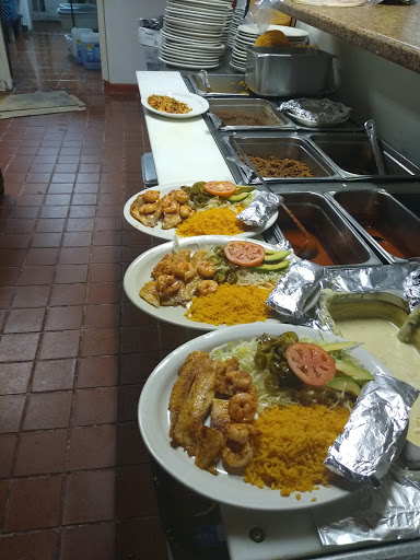 A variety of plated meals arranged on a table in a restaurant setting.