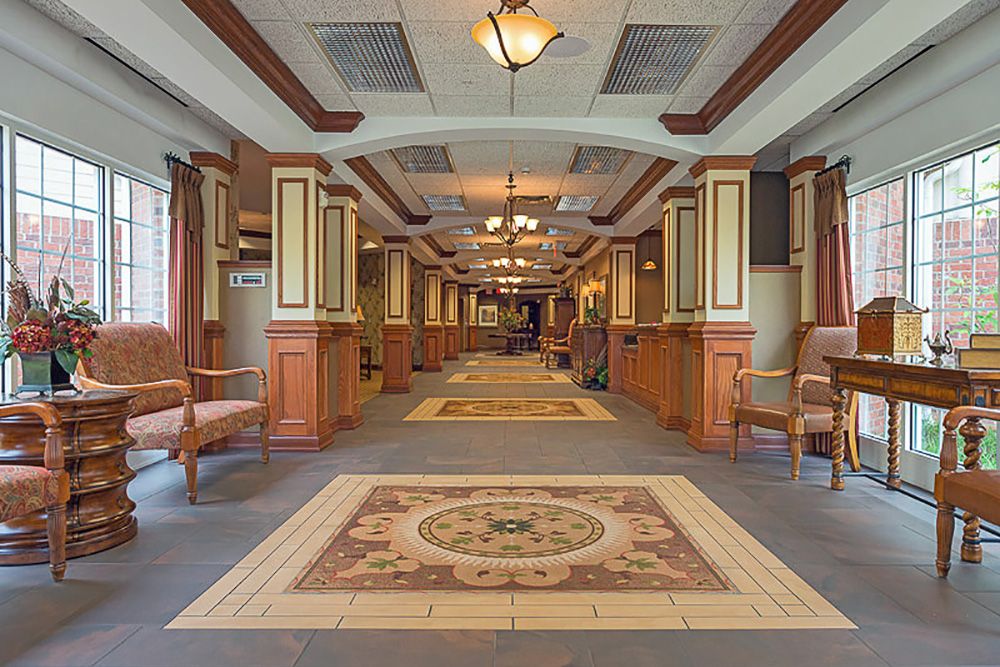 A well-lit, elegantly designed hallway with decorative elements and wood paneling.