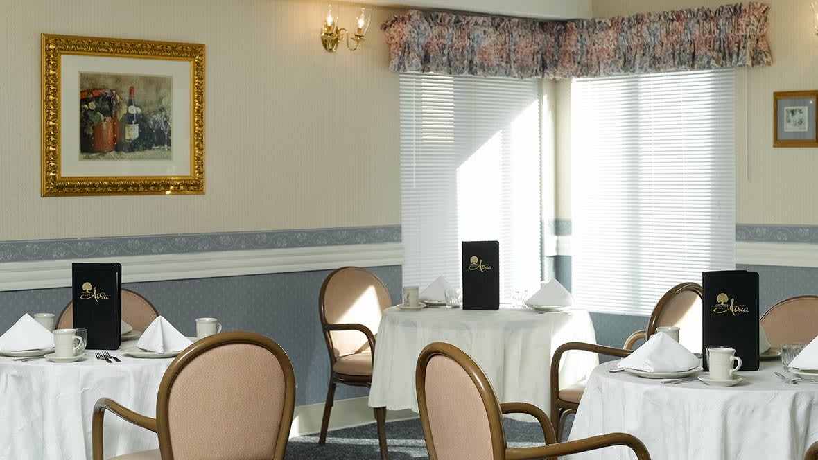 A cozy restaurant interior with elegant seating and sunlight streaming through the window.