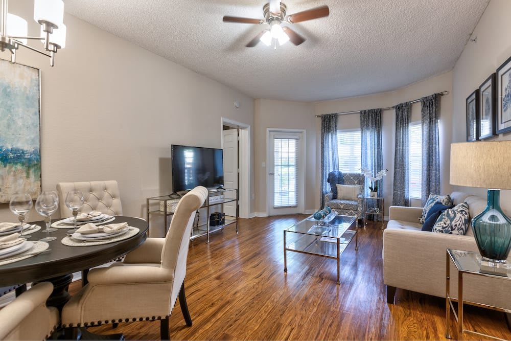 A cozy living room with a dining area, featuring modern decor and hardwood floors.
