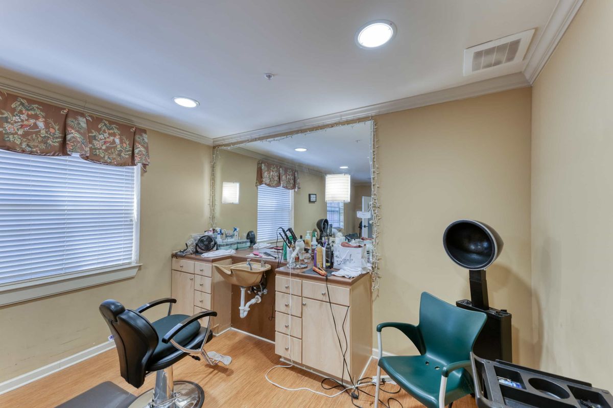 A neatly arranged hair salon interior with styling chairs and mirrors.