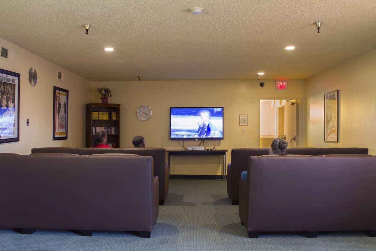 A cozy lounge area with comfortable seating and a television.